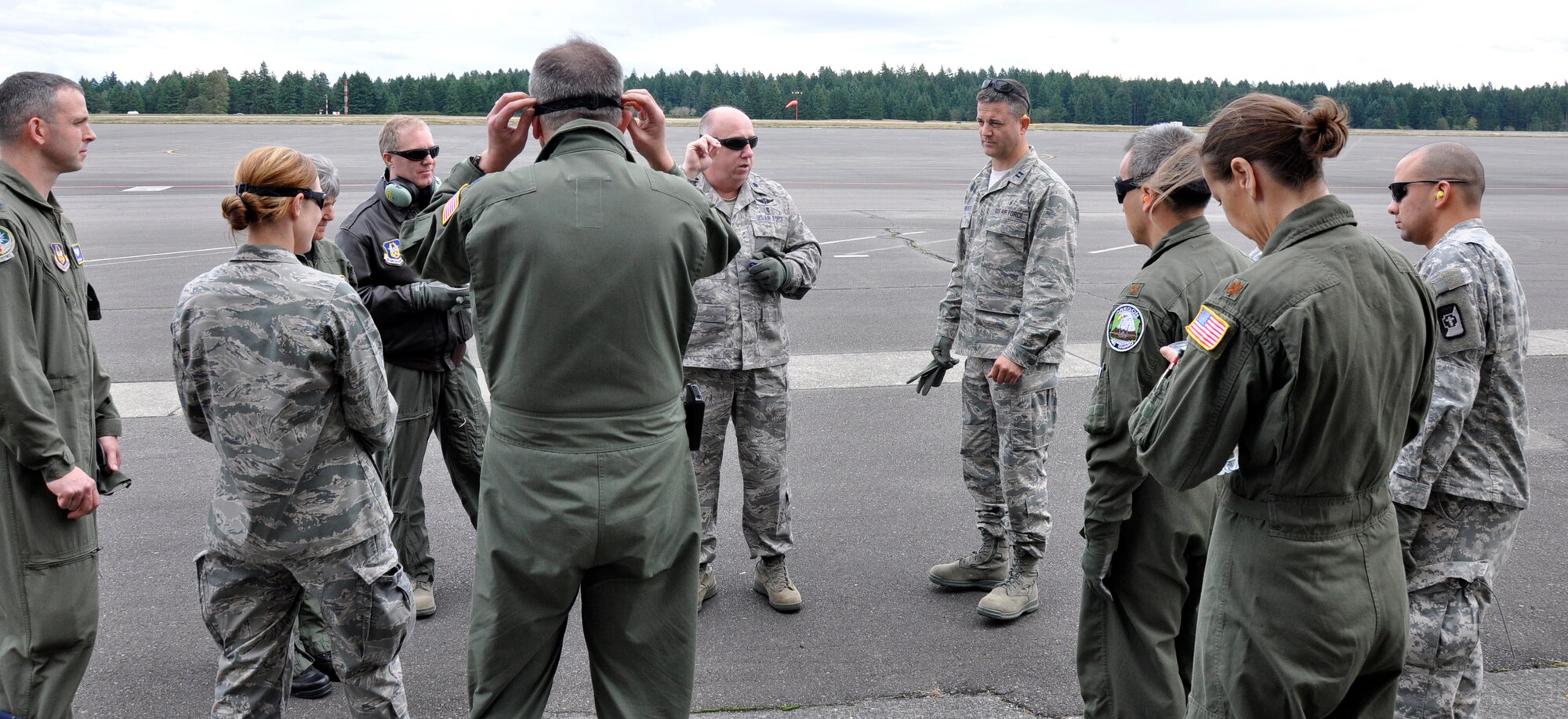 MCCHORD FIELD, Wash.- U.S. Air Force Lt. Col. Kenneth Winslow, (center with sunglasses) a flight nurse with the 446th Aeromedical Evacuation Squadron out of McChord Field, Wash., briefs Reservists from 446th AES and the 446th Aerospace Medicine Squadron while awaiting for an Army CH-47 Chinook helicopter, from Joint Base Lewis-McChord- Main, as part of a medical training exercise, Oct. 4, 2011. Some of the training covered was advanced cardiac life support training, which is a requirement of all AE members. (U.S. Air Force photo by Jake Chappelle)