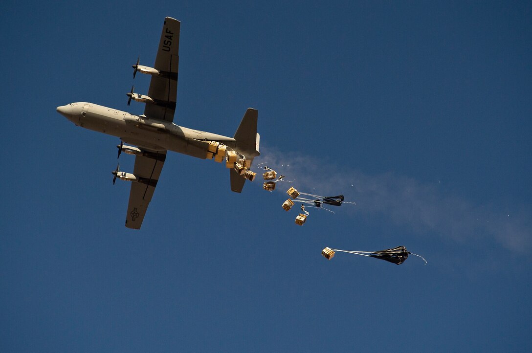 A U. S. Air Force C-130 Hercules airdrops 20 bundles of food rations to Forward Operating Base Edinburgh's drop zone in Helmand province, Afghanistan, Oct 3, 2011. 