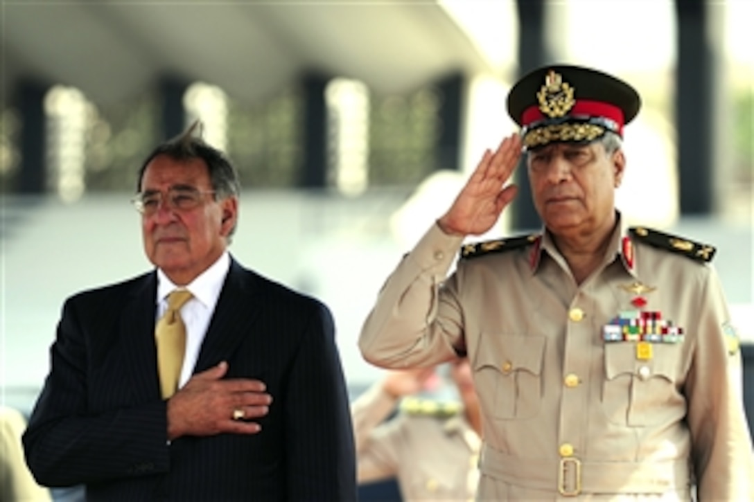 Secretary of Defense Leon Panetta stands beside Egyptian Maj. Gen. Rouini during the playing of the U.S. national anthem at the Tomb of the Unknown Soldier and President Anwar Sadat's memorial in Cairo, Egypt, on Oct. 4, 2011. Panetta is traveling in the Middle East to meet with key allies in the region to discuss a variety of defense related issues.  