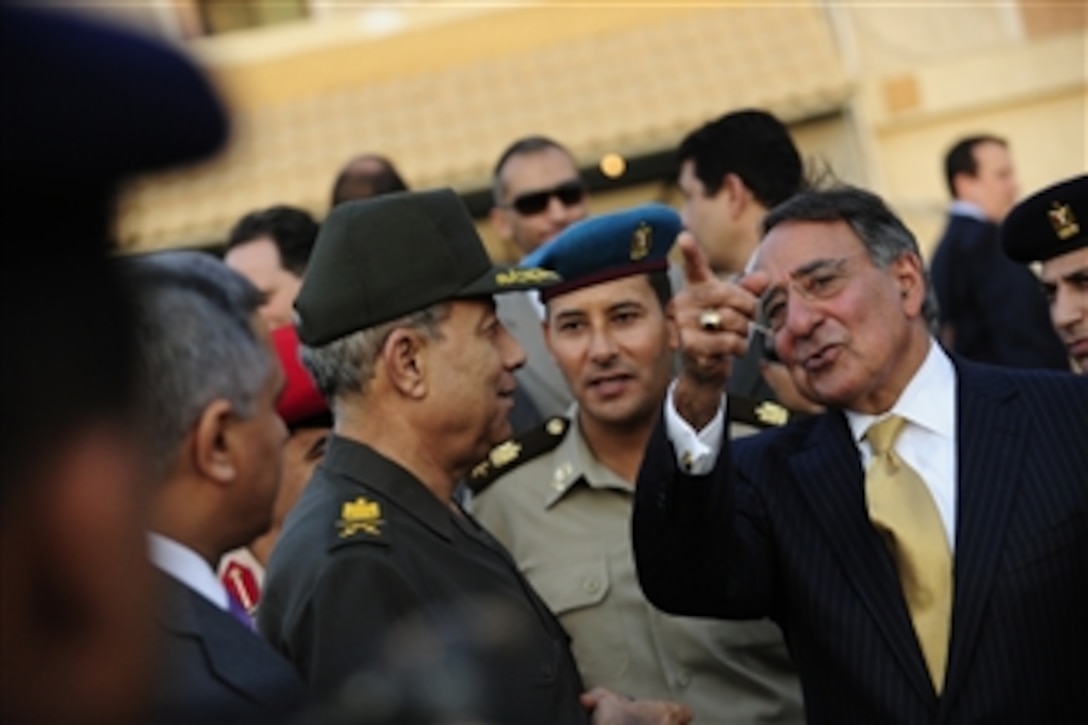 Secretary of Defense Leon Panetta talks with Egyptian Maj. Gen. Rouini as he prepares to leave Cairo, Egypt, on Oct. 4, 2011. Panetta is traveling in the Middle East to meet with key allies in the region to discuss a variety of defense related issues.  