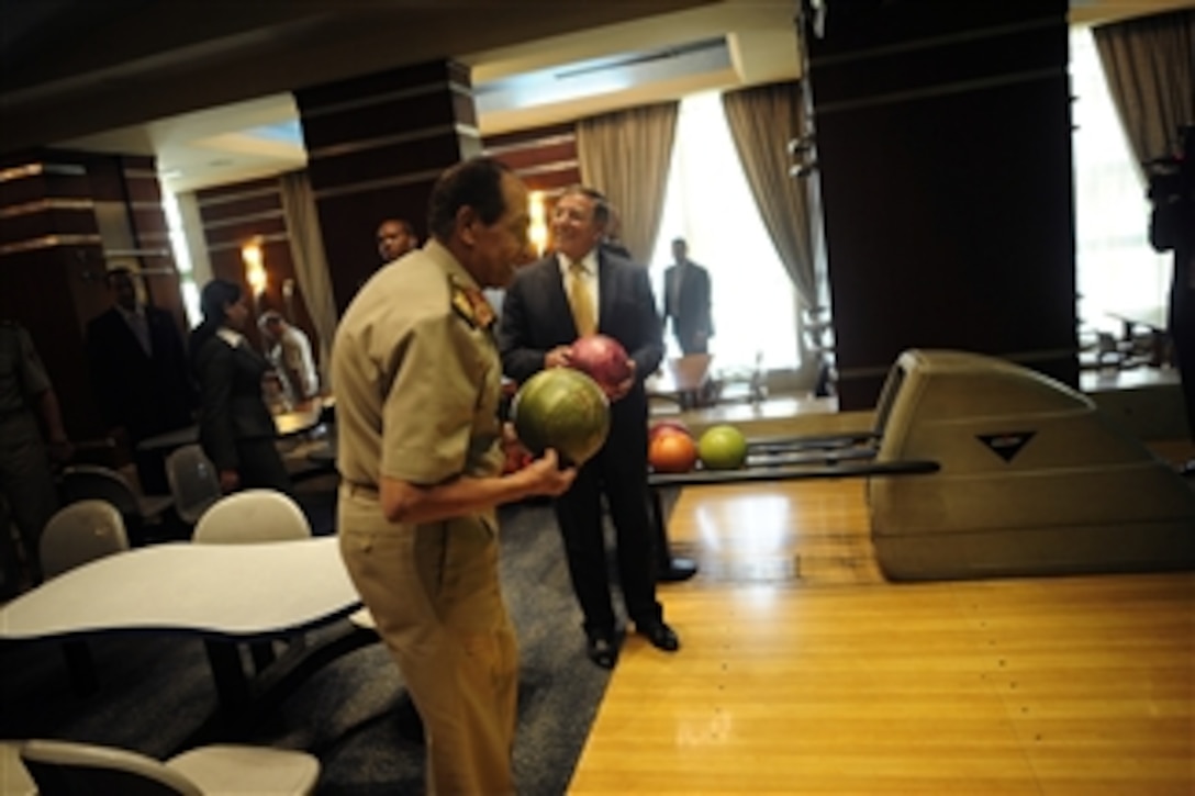 Field Marshal Hussein Tantawi and Secretary of Defense Leon Panetta enjoy an impromptu game of bowling while passing through a hotel's gallery in Cairo, Egypt, on Oct. 4, 2011. Panetta is traveling in the Middle East to meet with key allies in the region to discuss a variety of defense related issues.  