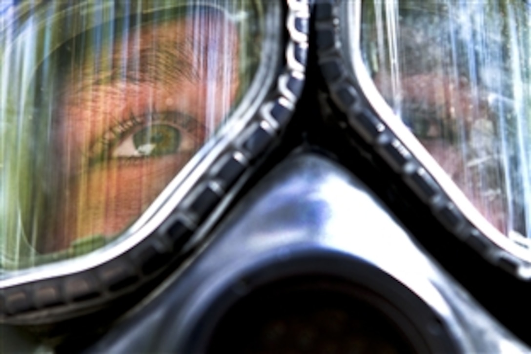A soldier wearing a gas mask prepares to enter a chamber of tear gas during training on Fort Bragg, N.C., Oct. 3, 2011. The soldier, a medic, is assigned to the 82nd Airborne Division’s 1st Brigade Combat Team. Soldiers must periodically show they are proficient at donning and sealing a gas mask under the duress of contact with a gas irritant such as tear gas.