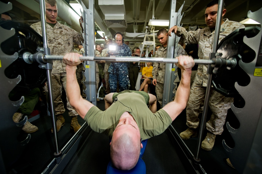 Cpl. Jacob Hunter bench presses 275 pounds during a competition aboard the amphibious assault ship Makin Island here Oct. 5. Gunnery Sgt. John Wellons won the competition by bench pressing 345 pounds. Hunter, 20, is from Easton, Pa., and is a communications Marine the 11th Marine Expeditionary Unit. The unit embarked USS Makin Island, the amphibious transport dock New Orleans and the dock landing ship Pearl Harbor in San Diego Sept. 28 and is participating in its final exercise before deploying in November.