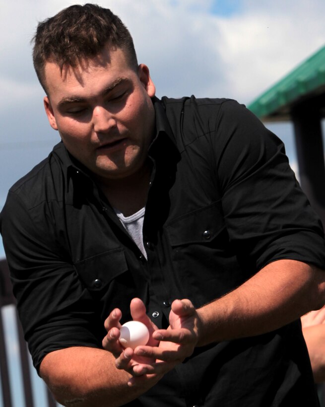 Lance Cpl. Collin Salisbury, motor transportation operator, Motor Transportation Company, Headquarters Battalion, 2nd Marine Division, catches an egg while competing in the egg toss during the Headquarters Battalion End of Summer Beach Bash held at Onslow Beach aboard Marine Corps Base Camp Lejeune, N.C., Oct. 6. The beach bash offered the Marines a number of competitions including volleyball, tug o’ war, horseshoes and finally an egg toss.