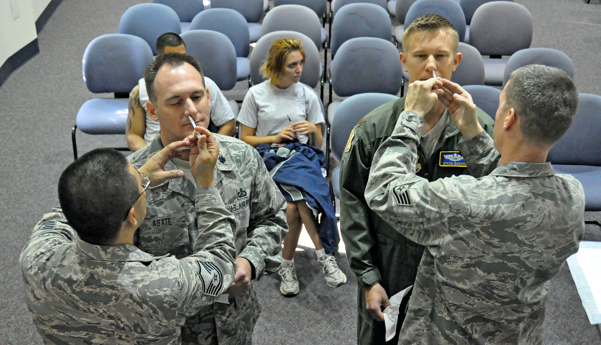 Lt. Col. Christopher Abate, 60th Comptroller Squadron commander, and Maj. Steve Dawson, 60th Air Mobility Wing deputy director of staff, receive the flu mist, an alternative to the flu shot, Sept. 29th during David Grant USAF Medical Center’s trip to different groups around Travis to distribute the flu vaccinations.  Those who have not received their vaccinations can contact the Immunization clinic at 707-423-5107. (U.S. Air Force photo/ Airman Madelyn Ottem)