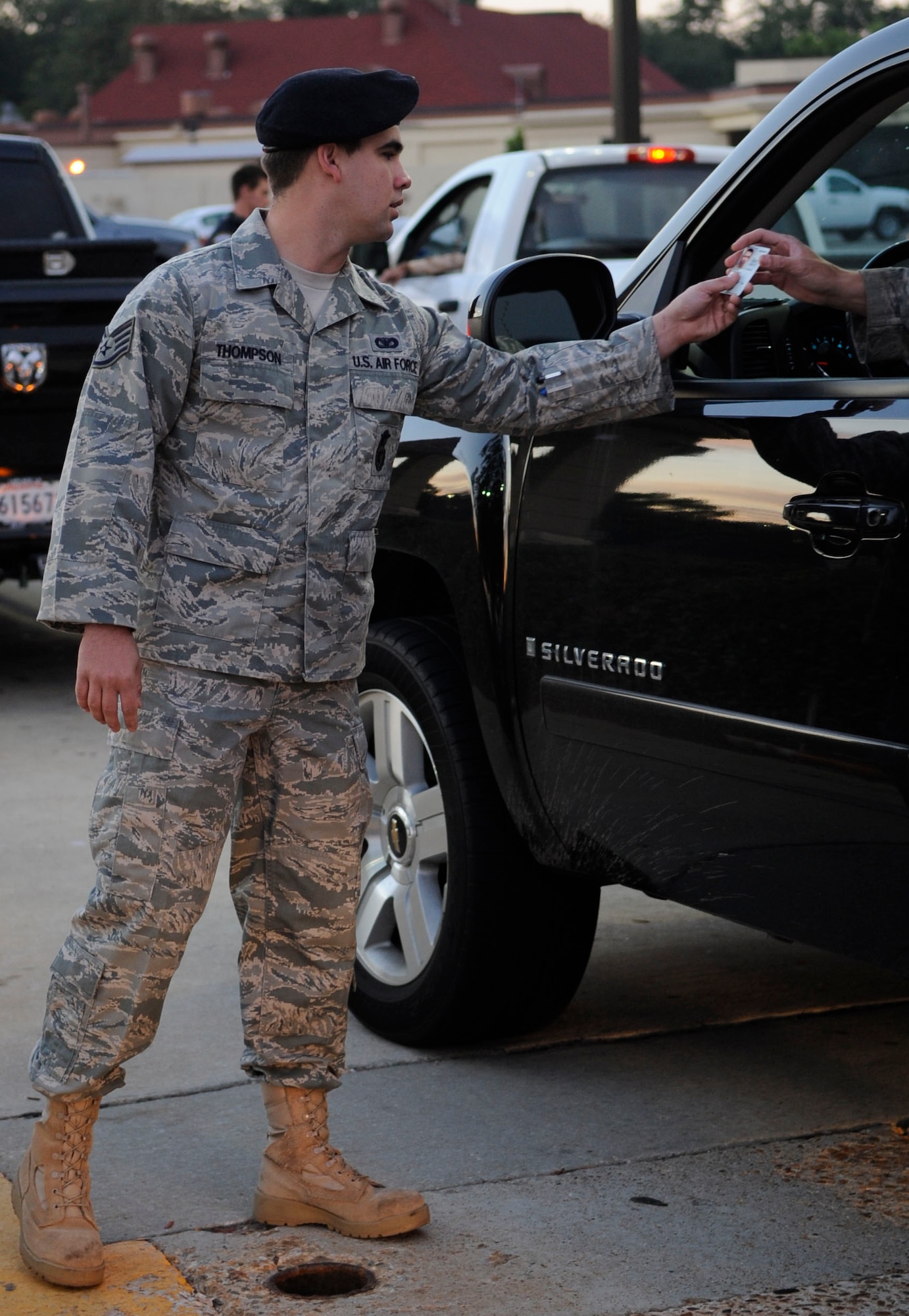 Staff Sgt. Garrett Thompson, 2nd Security Forces Squadron police services NCO, checks an Airman's identification card Oct. 6 at the North gate on Barksdale Air Force Base, La. Thompson is a recent recipient of the major command-level Government Employees Insurance Company Military Service Award for 2011 and is a nominee for the Air Force-level GEICO award. (U.S. Air Force photo/Airman 1st Class Andrea F. Liechti)(RELEASED)