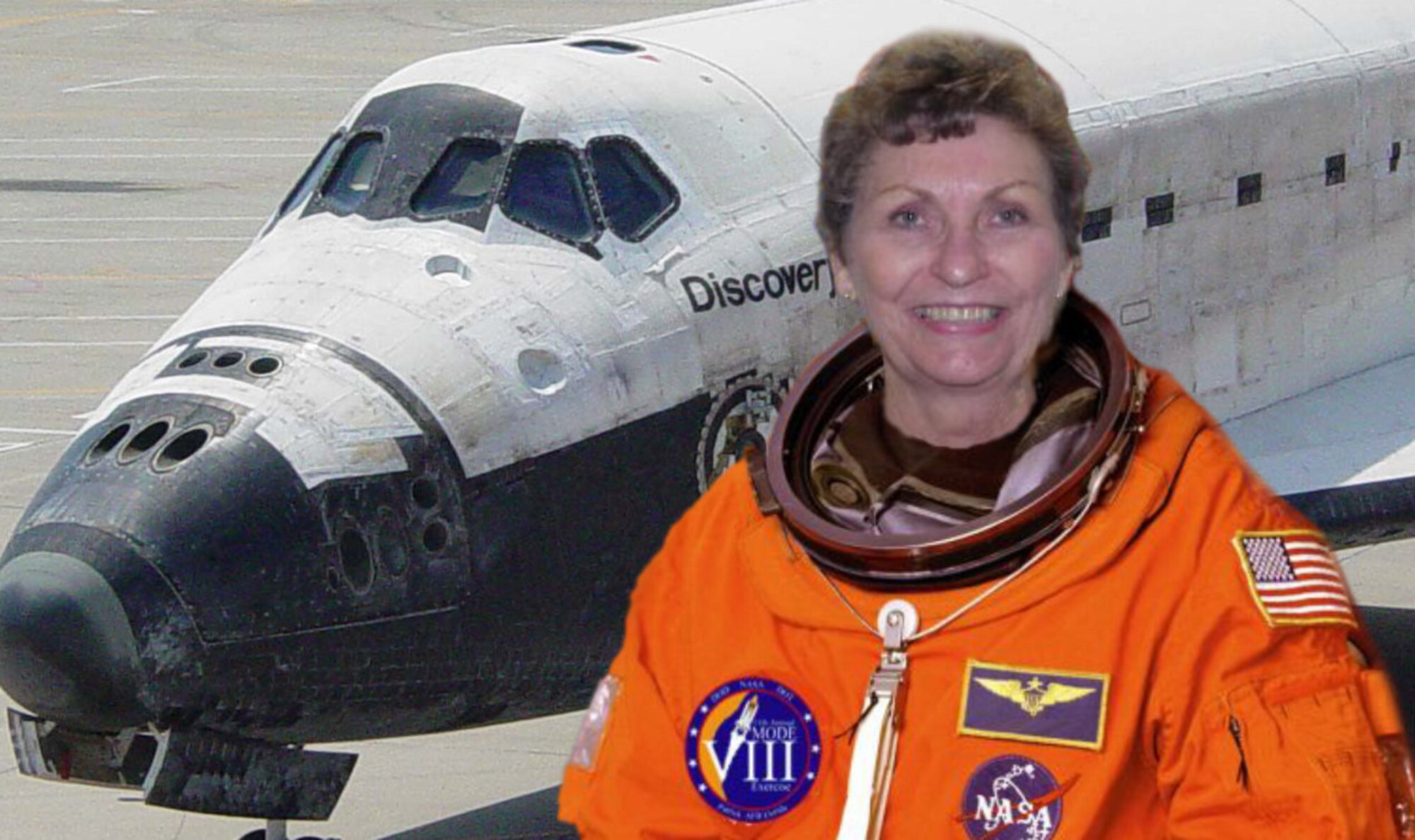 Bettye Krieter, long-time secretary to the commander, Human Space Flight Support Office, wears a spacesuit with Space Shuttle Discovery in the background. Her 32-year tenure with the unit spanned the entire length of the space shuttle program. She retired Sept. 29, 2011, from the 45th Space Wing, with 63 years of federal service. (Courtesy photo)