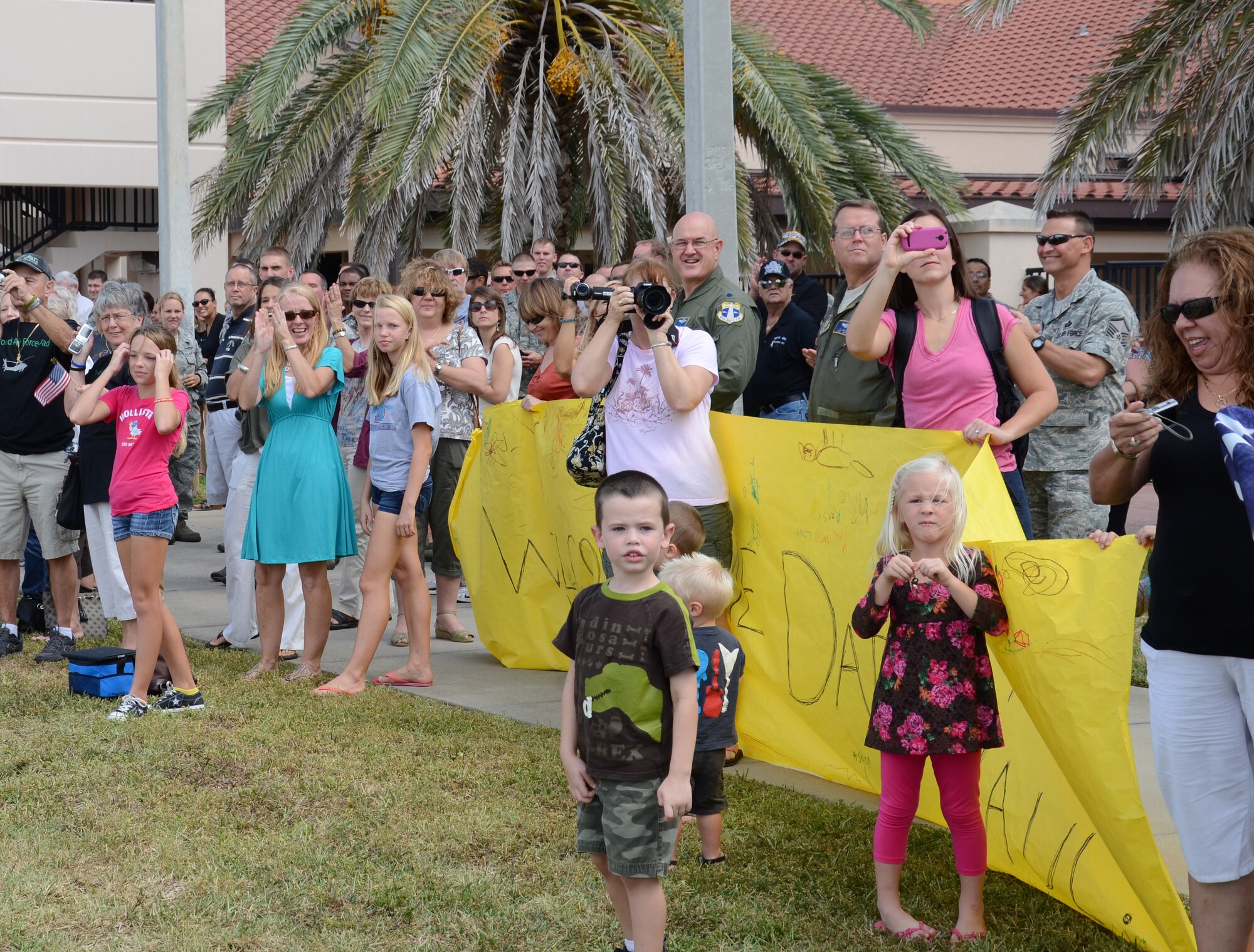PATRICK AIR FORCE BASE, Fla.- Family members cheer for the Rescue Reservists returning home after being deployed in Afghanistan for four months. The Rescue Reservists served as helicopter crewmembers, maintenance and support personnel as part of the 920th's yearlong deployment to save lives by using their skills and equipment to perform medical evacuation (MEDEVAC) operations - picking up the injured from combat zones to get them to treatment facilities. (U.S. Air Force photo/Airman 1st Class Natasha Dowridge)
