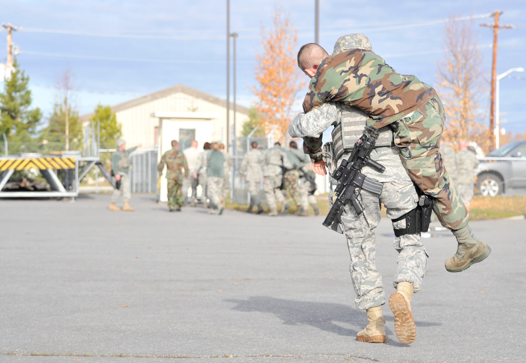 Airman 1st Class Matthew Phebus carries an injured person to safety during an active shooter exercise Sept. 28, 2011, Eielson Air Force Base, Alaska. The exercise provided the opportunity for first responders to practice real life scenarios while receiving feedback from evaluators. Phebus is an entry controller assigned to the 354th Security Forces Squadron. (U.S. Air Force photo/Staff Sgt. Christopher Boitz)