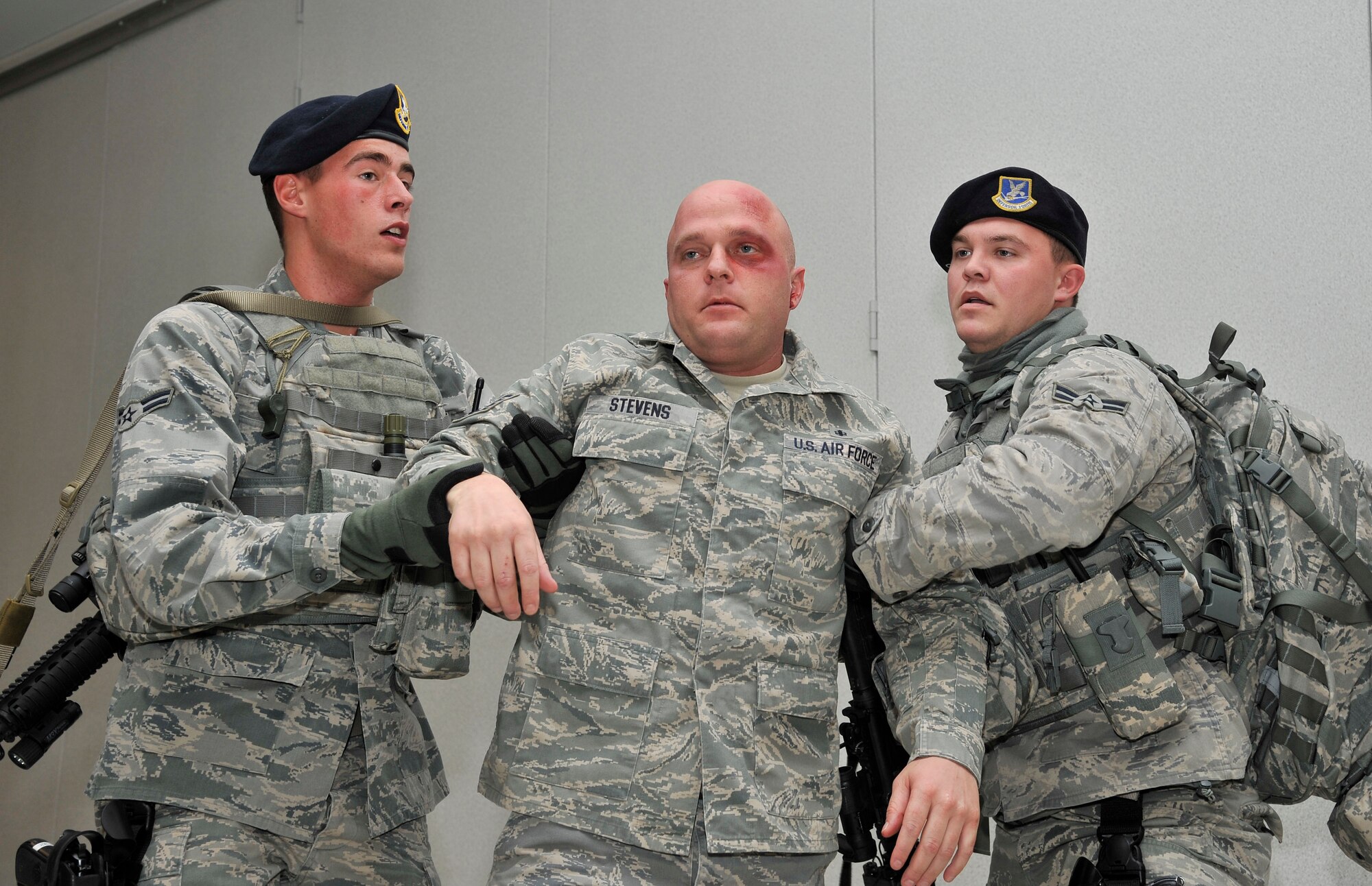 Airmen 1st Class Brian Walker and Thomas Graybill assist an injured person during an active shooter exercise Sept. 28, 2011, Eielson Air Force Base, Alaska. The exercise tested the capabilities of first responders on their ability to handle fast paced scenarios. Walker and Graybill are entry controllers assigned to the 354th Security Forces Squadron. (U.S. Air Force photo/Staff Sgt. Christopher Boitz)