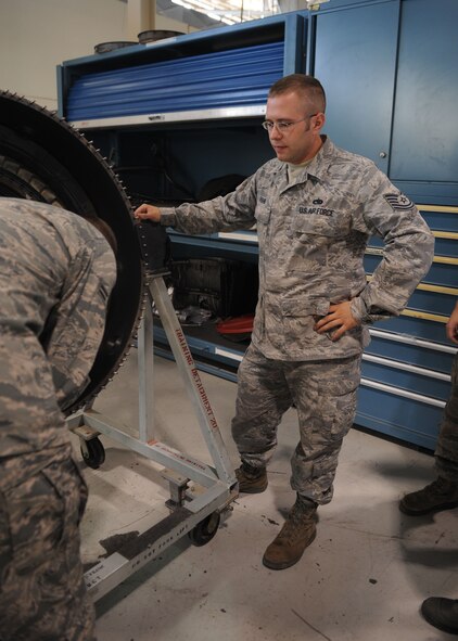 Tech. Sgt. Travis Fisher, 7th Component Maintenance Squadron, jet mechanic, watches a classmate work on a B-1 bomber engine, Oct. 4, 2011, at Dyess Air Force Base, Texas. Fisher came to Dyess from Spangdahelm Air Base, Germany, to participate in hands on training for the B-1 bomber. (U.S. Air Force photo by Airman 1st Class Cierra Bullock/Released)