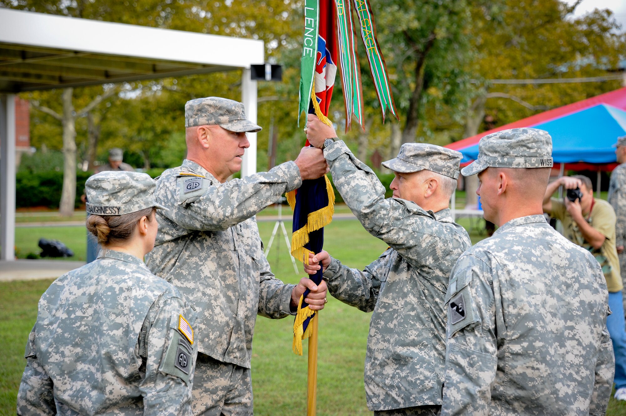 Maj. Gen. Jimmie Wells, 75th MCT Div. commanding general, passes the guidon to Brig. Gen. John Turner, incoming commander, Oct. 2 at Sharp Field. Brig. Gen. Karlynn O’Shaughnessy, outgoing commander, relinquished command and retired immediately after. Civil War historians from the 1st New Jersey Light Artillery, Battery A fired their cannon in honor of her 33 years of service.  (U.S. Air Force photo by Airman Ryan Throneberry/Released)