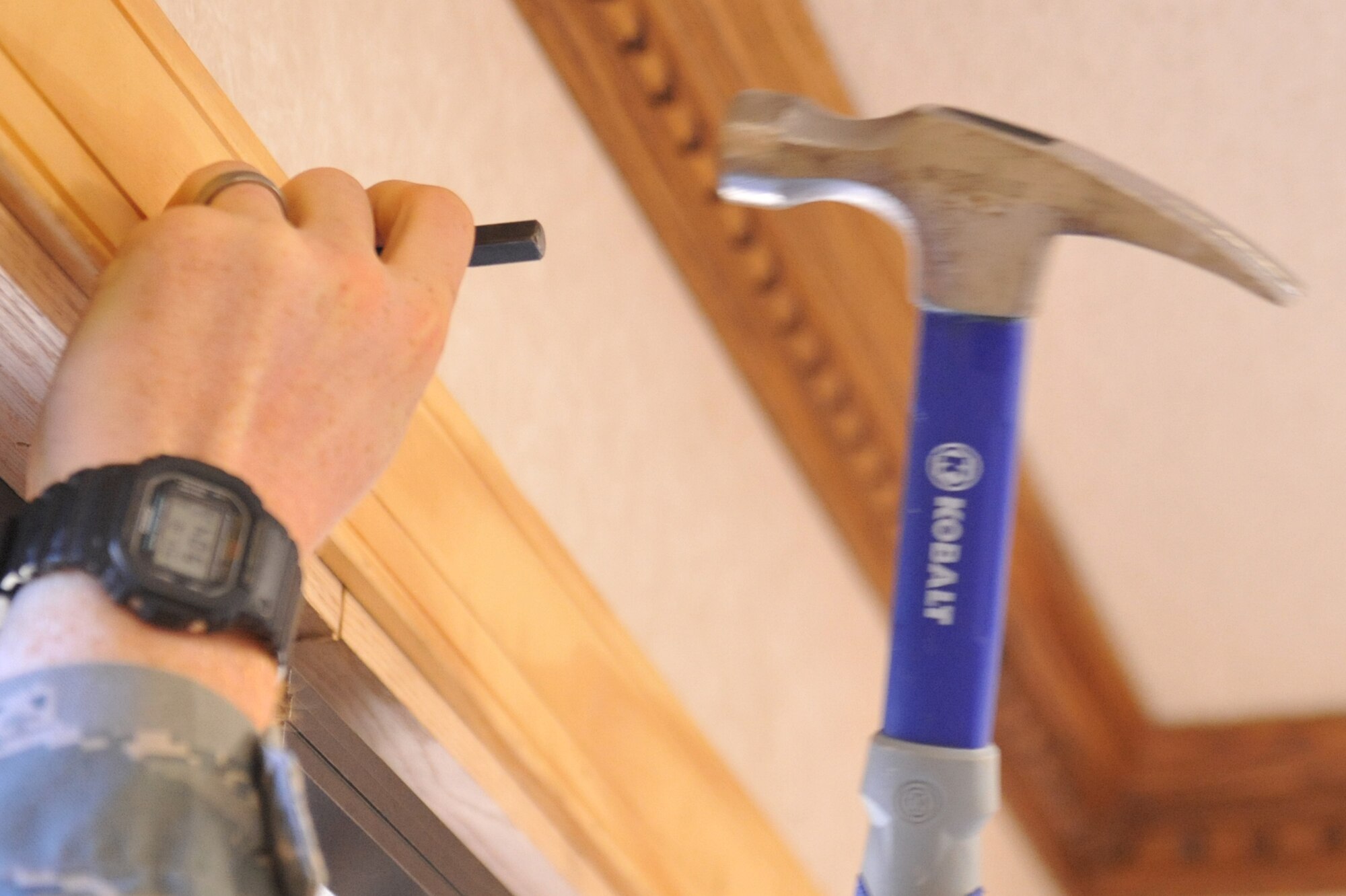 Airman 1st Class Calvin Myers swings a hammer at a nailset during a visitor?s center project on Seymour Johnson Air Force Base, N.C., Oct. 4, 2011. Nailsets are used to drive in nails without damaging wood. Myers is a 4th Civil Engineer Squadron structural journeymen and a native of Asheville, N.C. (U.S. Air Force photo by Senior Airman Whitney Stanfield)