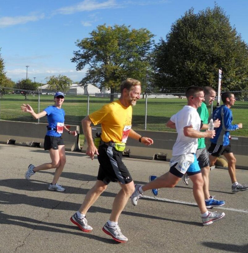 Master Sgt. Fern Michael, interim NCOIC of the 446th ASTS support flight, shows no mercy as she waves and smiles her way through the 13.1 mile course at Wright-Patterson Air Force Base Sept. 17.  Michael was thrilled to have the opportunity to participate in her second half marathon and dominated it in 1:52.  (U.S. Air Force photo by Staff Sgt. Jennifer White)