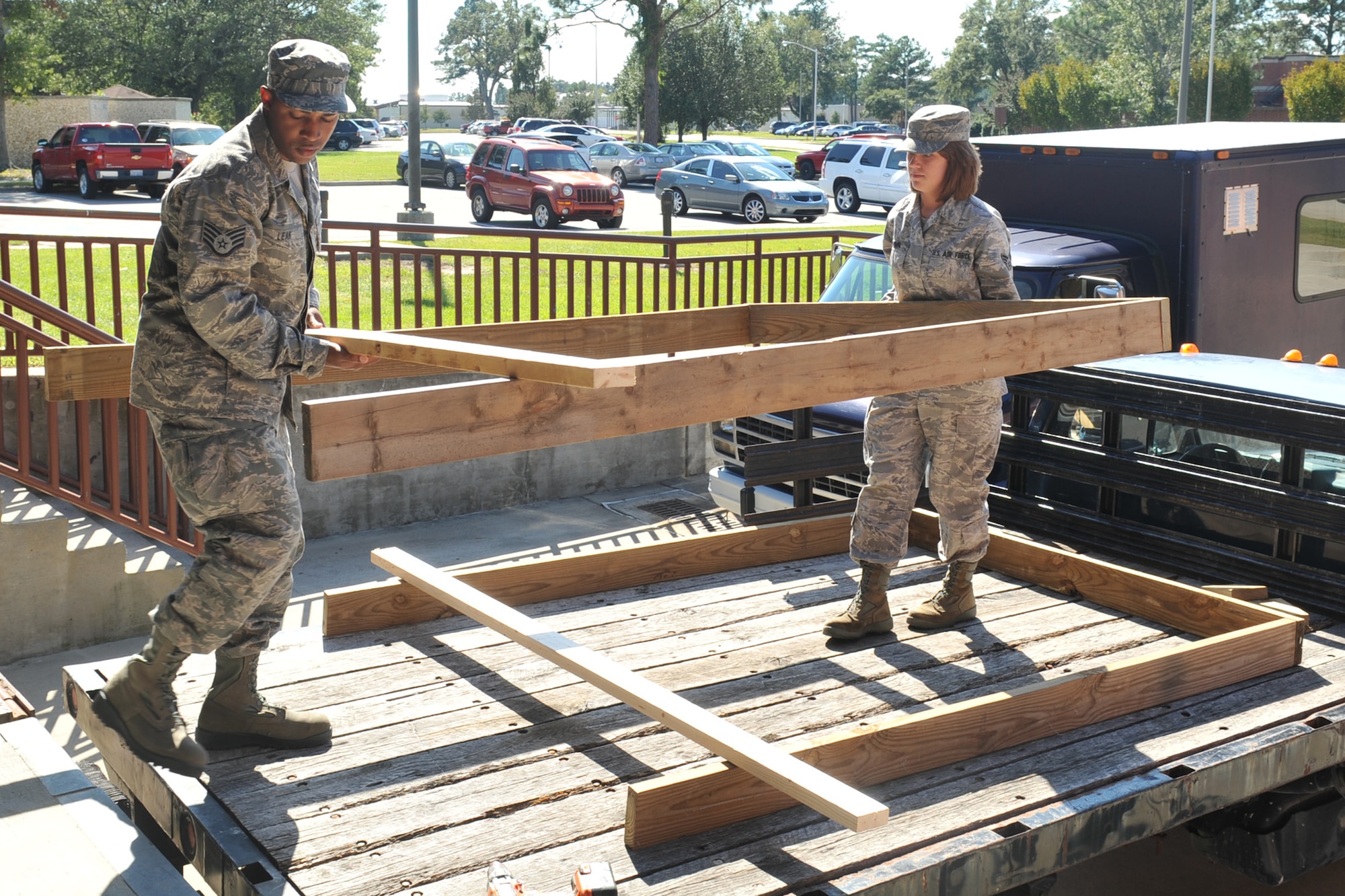 Staff Sgt. Marius Leak and Senior Airman Keny Brown remove a frame for a structural project on Seymour Johnson Air Force Base, N.C., Oct. 4, 2011. Structural journeymen take all the equipment needed to complete a project to the job site. Leak is a 4th Civil Engineer Squadron structural craftsman and hails from High Pont, N.C.  Brown is a 4 CES structural journeyman and a native of Savannah, Ga. (U.S. Air Force photo by Senior Airman Whitney Stanfield)