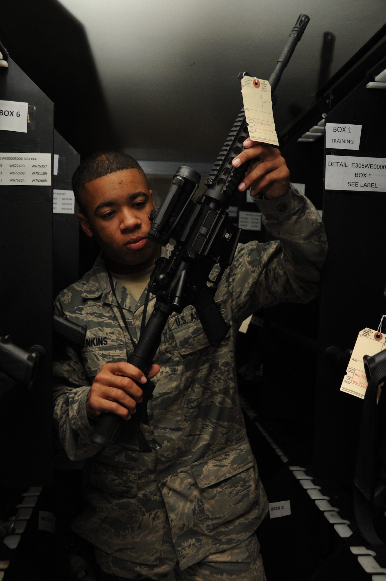 Airman 1st Class Kevin Jenkins with the 87th Logistics Readiness Squadron, Individual Protective Equipment Element, inspects an M-4 rifle for the weapon’s serial number as part of an inventory check. This bi-annual process ensures the high inventory accountability rate will stay that way. Members of the IPEE provide Airmen with gear for contingency response, real-world deployments and training. (U.S. Air Force photo by Airman Ryan Throneberry/Released)