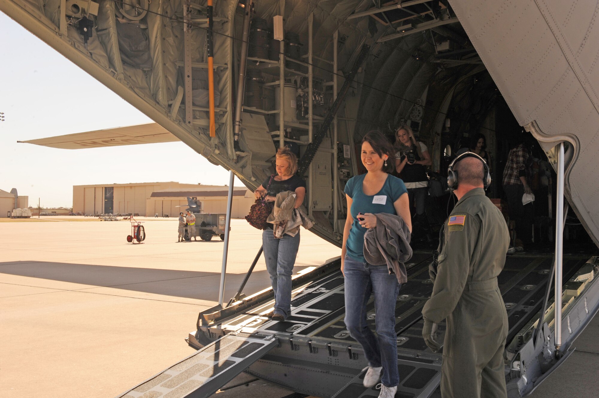 Dyess spouses exit a C-130J after a 30 minute flight, Sept. 30, 2011, at Dyess Air Force Base, Texas. The flight allowed spouses a chance to see what their significant other does on a daily basis. (U.S. Air Force photo by Airman 1st Class Cierra Bullock/Released)
