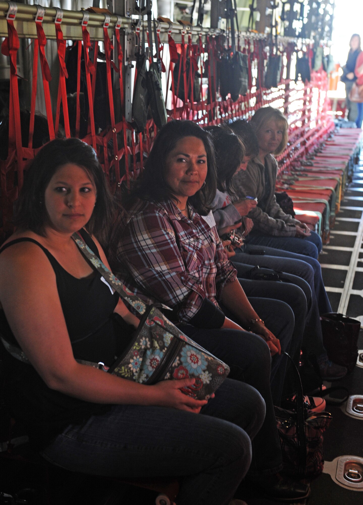 Dyess spouses sit in a C-130J awaiting take off, Sept. 30, 2011, at Dyess Air Force Base, Texas. The flight allowed spouses a chance to see what their significant other does on a daily basis. (U.S. Air Force photo by Airman 1st Class Bullock/Released)