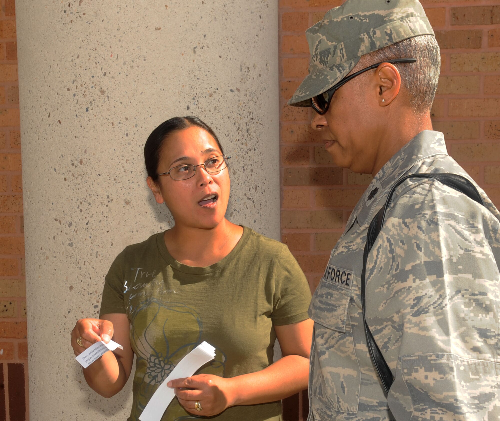 Tech. Sgt. Jenalyn Owens, 2nd Bomb Wing Legal office, speaks with Lt. Col. Brenda Nelson, 2nd Medical Group, about Operation Warm Heart at the commissary on Barksdale Air Force Base, La., Oct. 4. Operation Warm Heart unites Airmen, veterans and civilians taking care of each other in the spirit of family, sacrifice and care. (U.S. Air Force photo/Senior Airman Kristin High)(RELEASED)