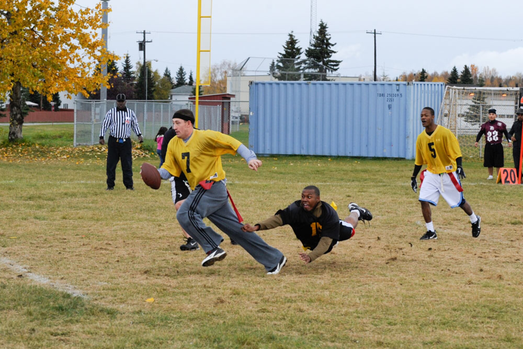 Andrew Gaskins of the 56th Engineer Company breaks free of attempted tackles at the intramural flag football tournament Sunday. (U.S. Air Force Photos/Steven White)