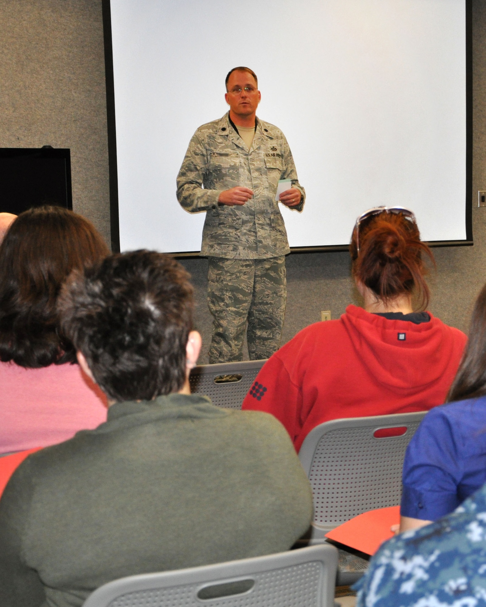 Lt. Col. James, 30th Intelligence Squadron commander, speaks to a group of spouses Sept. 28 at the 497th Intelligence, Surveillance and Reconnaissance Group at Langley Air Force Base, Va. The group was offered a rare tour of the facility to provide insight into what their spouses do on a daily basis. (U.S. Air Force photo by Tech. Sgt. Randy Redman/Released)