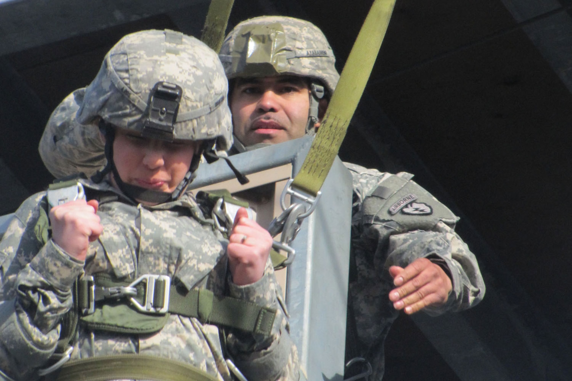 Jumpmaster Sgt. 1st Class  Tony Ayaberrano helps a spouse out of the training tower on Joint Base Elmendorf-Richardson. (U.S. Army photo/Spc. Philip Cooper)