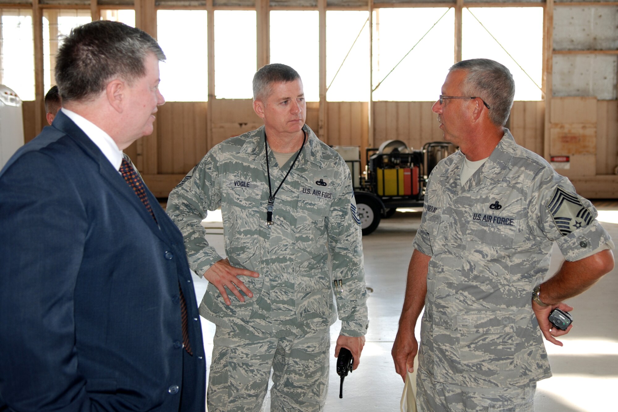 Mr. William Redmond, Air Force Reserve Command Director of Staff, talks with U.S. Air Force Chief Master Sgts. Steve Vogle, 307th Aircraft Maintenance Squadron maintenance superintendent, and Robert Murray, 307th Maintenance Squadron superintendent, during his visit to Barksdale Air Force Base, La., Oct. 5, 2011. The Air Force Reserve Command's 33 wings and six groups operate at 10 Reserve bases and on 56 other bases throughout the Air Force. (U.S. Air Force photo by Senior Master Sgt. Jessica D'Aurizio/Released)