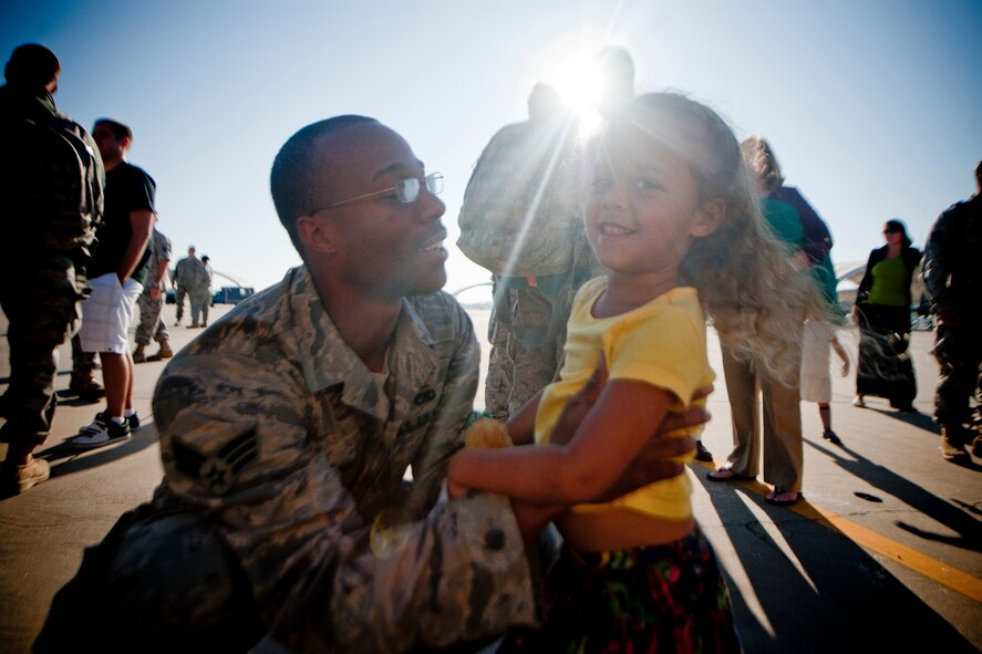 U.S. Air Force Senior Airman William Purnell, 23rd Aircraft Maintenance Squadron, plays with his daughter, Sienna, after returning home from deployment Oct. 6, 2011, at Moody Air Force Base, Ga. During the six-month deployment, Purnell helped maintain the A-10C Thunderbolt II aircraft which flew sorties from Kandahar Air Field, Afghanistan, in support of Operation Enduring Freedom. (U.S. Air Force photo by Staff Sgt. Jamal D. Sutter/Released)   