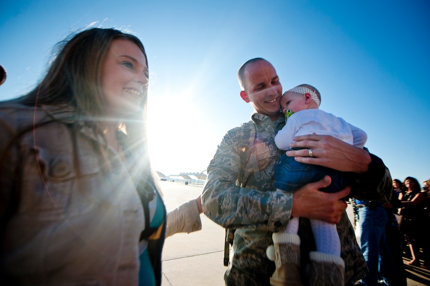 U.S. Air Force Tech. Sgt. Jason Smith holds his daughter, Isabella, for the very first time after returning home from deployment Oct. 6, 2011, at Moody Air Force Base, Ga. Smith was part of a deployment to Kandahar Air Field, Afghanistan, with the 74th Fighter Squadron, 74th Aircraft Maintenance Unit, 23rd Equipment Maintenance Squadron, 23rd Component Maintenance Squadron and 23rd Maintenance Operations Squadron. Isabella was born April 6, shortly after his departure to the desert. (U.S. Air Force photo by Staff Sgt. Jamal D. Sutter/Released)