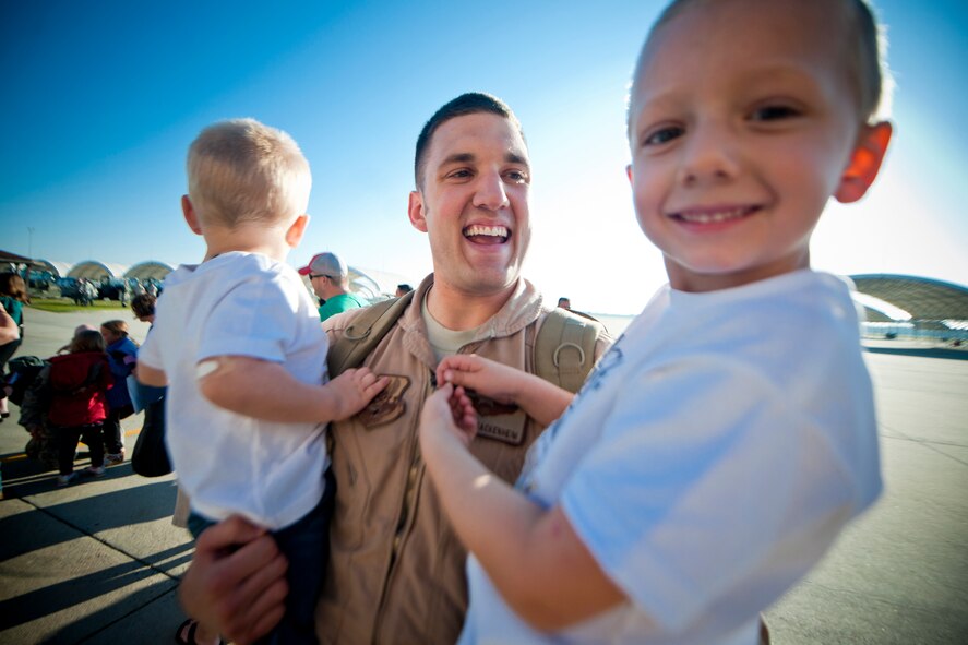 U.S. Air Force Capt. Michael Sackenheim, 74th Fighter Squadron A-10 pilot, shares smiles with his sons, Matthew and Jacob, after returning home from deployment Oct. 6, 2011, at Moody Air Force Base, Ga. During the deployment, Sackenheim flew the A-10C Thunderbolt II aircraft in support of U.S. and coalition ground forces in Kandahar Air Field, Afghanistan. (U.S. Air Force photo by Staff Sgt. Jamal D. Sutter/Released)