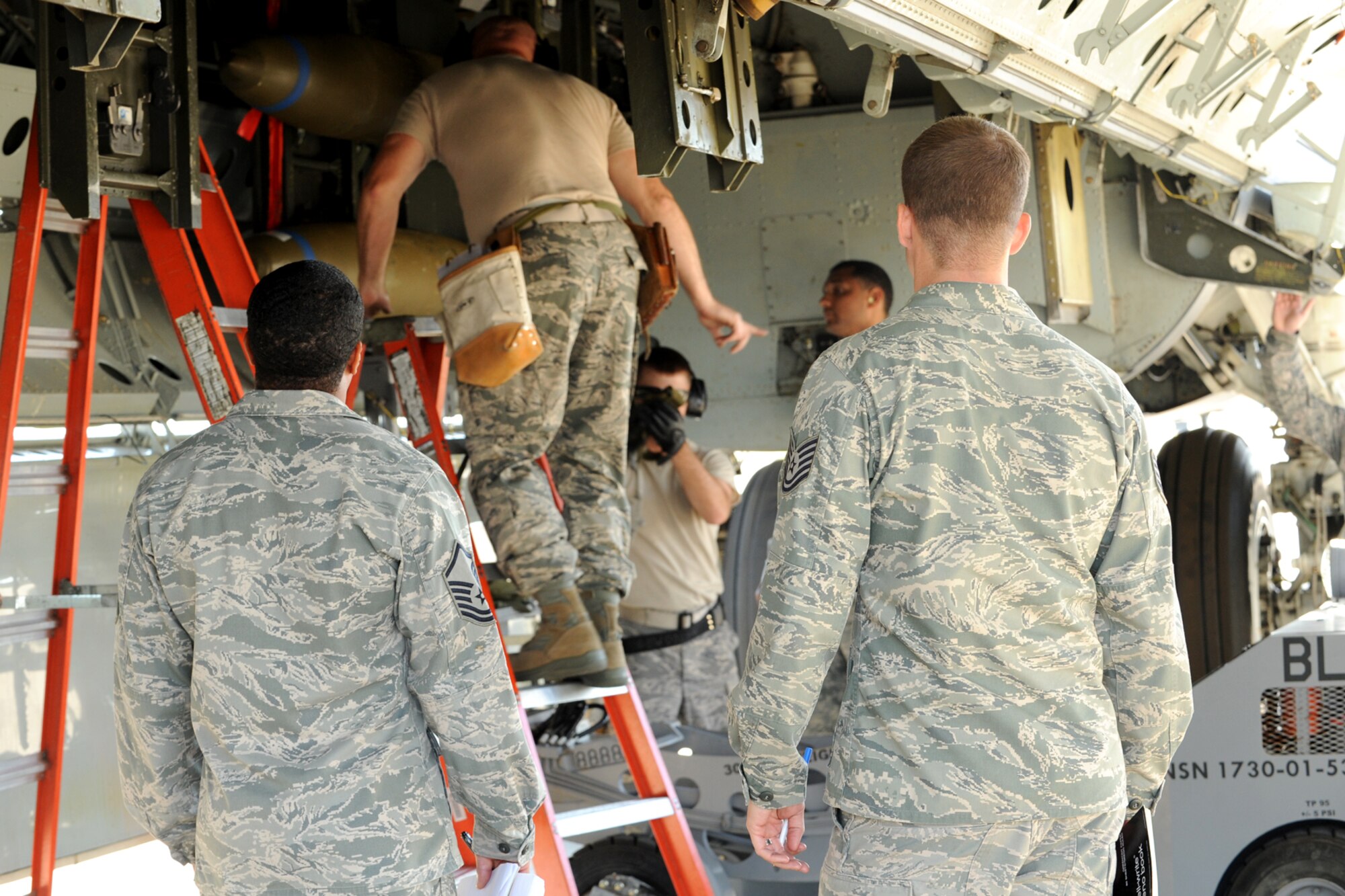 Members of the Global Strike Challenge team evaluate 307th Aircraft Maintenance Squadron weapons loaders as they load simulated MK-82, 500-pound general purpose bombs, in the bomb bay of a B-52 Stratofortress at Barksdale Air Force Base, La., Oct. 5, 2011. The Global Strike Challenge is the world's premier bomber, Intercontinental Ballistic Missile and security forces competition with units from the Air Force Global Strike Command, Air Combat Command, Air Force Reserve Command and the Air National Guard, and the official score-posting will be at Barksdale, Nov 8-9. (U.S. Air Force photo by Master Sgt. Greg Steele/Released)