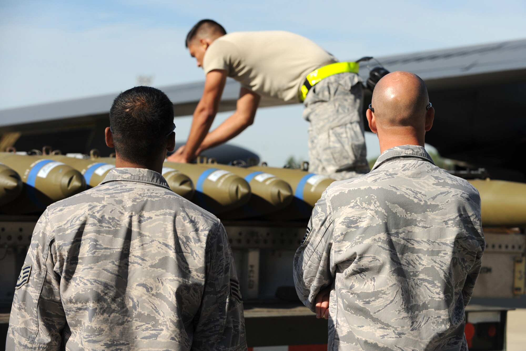 Members of the Global Strike Challenge team evaluates U.S. Air Force Senior Airman Luis Sanchez, 307th Aircraft Maintenance Squadron weapons loader, as he prepares a trailer of simulated MK-82, 500-pound general purpose bombs, for loading in the bomb bay of a B-52 Stratofortress at Barksdale Air Force Base, La., Oct. 5, 2011. The Global Strike Challenge is the world's premier bomber, Intercontinental Ballistic Missile and security forces competition with units from the Air Force Global Strike Command, Air Combat Command, Air Force Reserve Command and the Air National Guard, and the official score-posting will be at Barksdale, Nov 8-9. (U.S. Air Force photo by Master Sgt. Greg Steele/Released)
