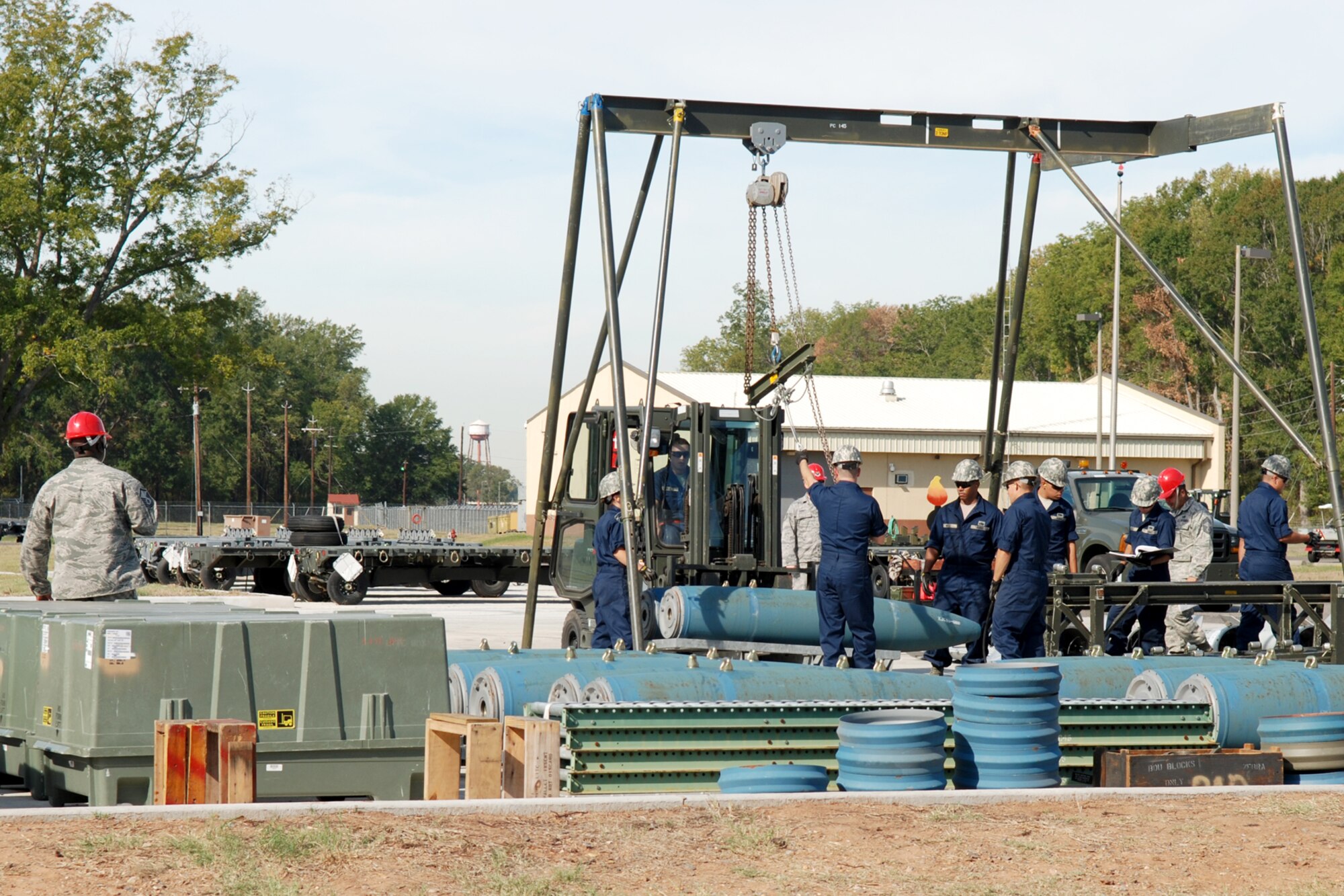 A member of the Global Strike Challenge team (red hard hat) evaluates 307th Maintenance Squadron munitions technicians as they assemble simulated 2000-pound Joint Direct Attack Munitions at Barksdale Air Force Base, La., Oct. 5, 2011. The Global Strike Challenge is the world's premier bomber, Intercontinental Ballistic Missile and security forces competition with units from the Air Force Global Strike Command, Air Combat Command, Air Force Reserve Command and the Air National Guard, and the official score-posting will be at Barksdale, Nov 8-9. (U.S. Air Force photo by Senior Master Sgt. Jessica D’Aurizio/Released)