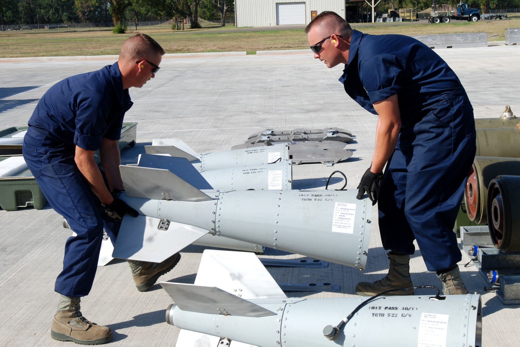 U.S. Air Force Tech. Sgt. Greg Currence and Staff Sgt. Cory Parchman, 307th Maintenance Squadron munitions technicians, position guidance fins for simulated 2000-pound Joint Direct Attack Munitions during a bomb-build evaluation for the 2nd annual Global Strike Challenge at Barksdale Air Force Base, La., Oct. 5, 2011. The Global Strike Challenge is the world's premier bomber, Intercontinental Ballistic Missile and security forces competition with units from the Air Force Global Strike Command, Air Combat Command, Air Force Reserve Command and the Air National Guard, and the official score-posting will be at Barksdale, Nov 8-9. (U.S. Air Force photo by Senior Master Sgt. Jessica D’Aurizio/Released)