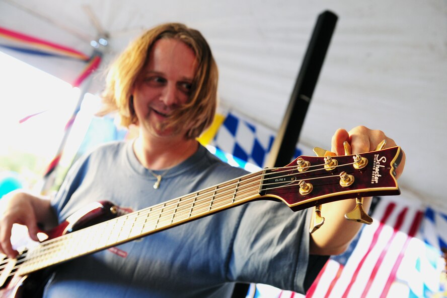 Wolfgang Lackner, Alpenmusikanten bass guitarist, tunes his bass prior to the start of Oktoberfest on Barksdale Air Force Base, La., Sept. 30. Alpenmusikanten, a five-member band, specializes in traditional German fest music normally played at Oktoberfest events. (U.S. Air Force photo/Airman 1st Class Benjamin Gonsier)(RELEASED)