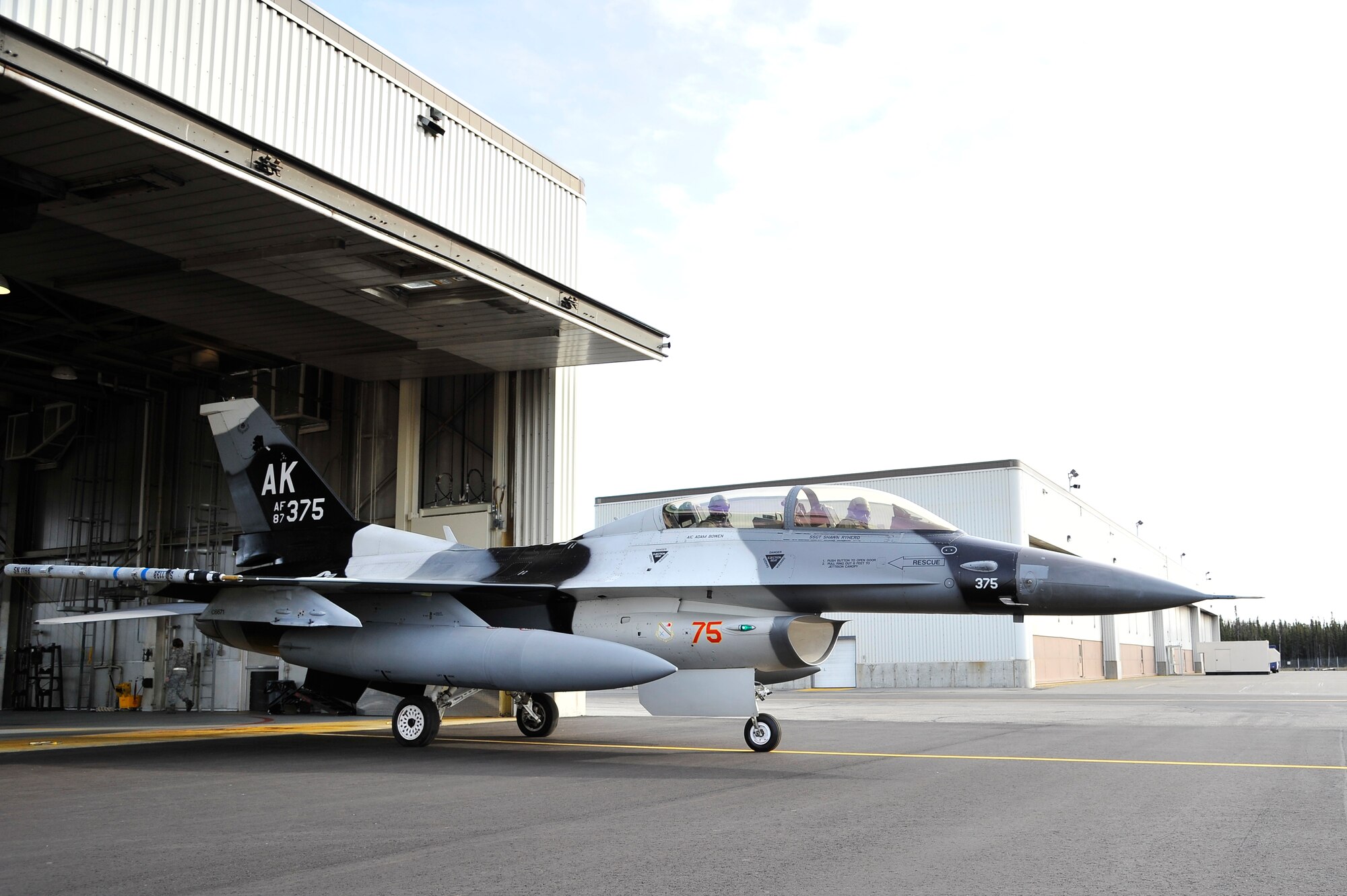 Lt. Col. Todd Emmons and Ryan Binkley taxi towards the flightline in an F-16 Fighting Falcon Aggressor for a familiarization flight Sept 29, 2011, Eielson Air Force Base, Alaska. Emmons is the 18th Aggressor Squadron commander and Binkley is the honorary commander of the 18th AGRS and is the Riverboat Discovery president. (U.S. Air Force photo/Staff Sgt. Christopher Boitz)