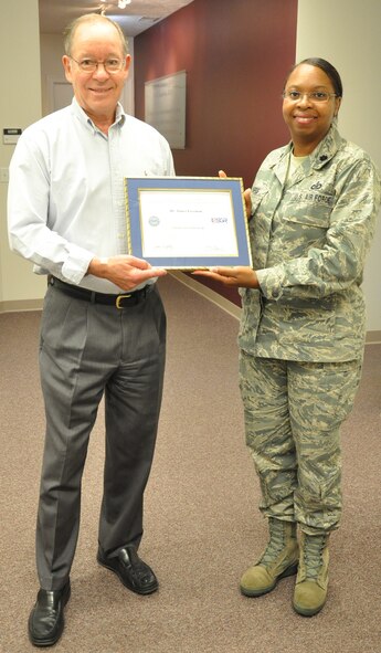 WRIGHT-PATTERSON AIR FORCE BASE, Ohio – Lt. Col. Cynthia Harris, 445th Airlift Wing, presents Dr. James Freeman with the Employer Support of the Guard and Reserve Patriot Award Oct. 4 in recognition for his support of Mrs. Leslie Hutchison, wife of Tech. Sgt. Jason Hutchison, 445th Aeromedical Evacuation Squadron. Leslie nominated Drs. Freeman and Lee Hendricks for the award for their support of her and her family while her husband was deployed. (U.S. Air Force photo/Stacy Vaughn)