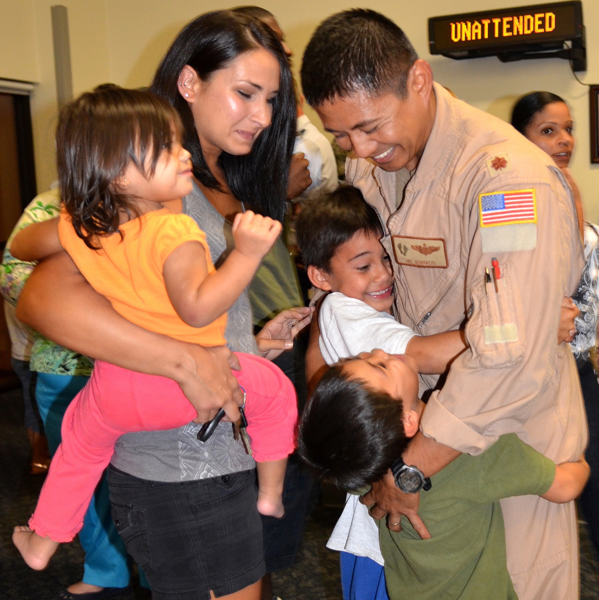 PATRICK AIR FORCE BASE, Fla. - Maj. Melvin Bonifacio, HH-60G Pave Hawk helicopter pilot, hugs his boys upon his return from a 4-month deployment in support of Operation Enduring Freedom. During this rotation, the reservists are credited with flying 505 rescue missions; successfully saving 358 lives; and assisting in saving another 287 lives. (U.S. Air Force photo/Staff Sgt. Leslie Forshaw)