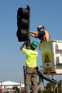HANSCOM AIR FORCE BASE, Mass. – Crews work on the traffic lights at the corner of Barksdale and Marrett streets Sept. 27.  The new signals feature modern actuated controls, a protected left turn, pedestrian cross walk signals and emergency vehicle preemption that will automatically change the traffic signals to give priority to emergency vehicles. The lights at the corner of Barksdale and Grenier streets will also be replaced soon. (U.S. Air Force photo by Linda LaBonte Britt)