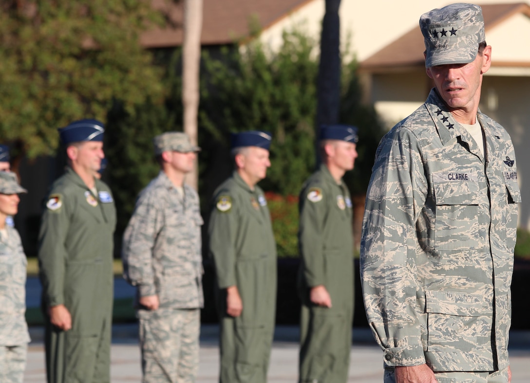 Lt. Gen. Sid Clarke, 1st Air Force commander, issues the present arms command to a formation of 1st AF members during a formal Air Force Retreat ceremony at the 325th Fighter Wing Flag Park at Tyndall Air Force Base, Fla., Oct. 5. Retreat is military tradition that pays tribute to the American flag and signifies the end of the duty day. (U.S. Air Force photo by Angela Pope) 