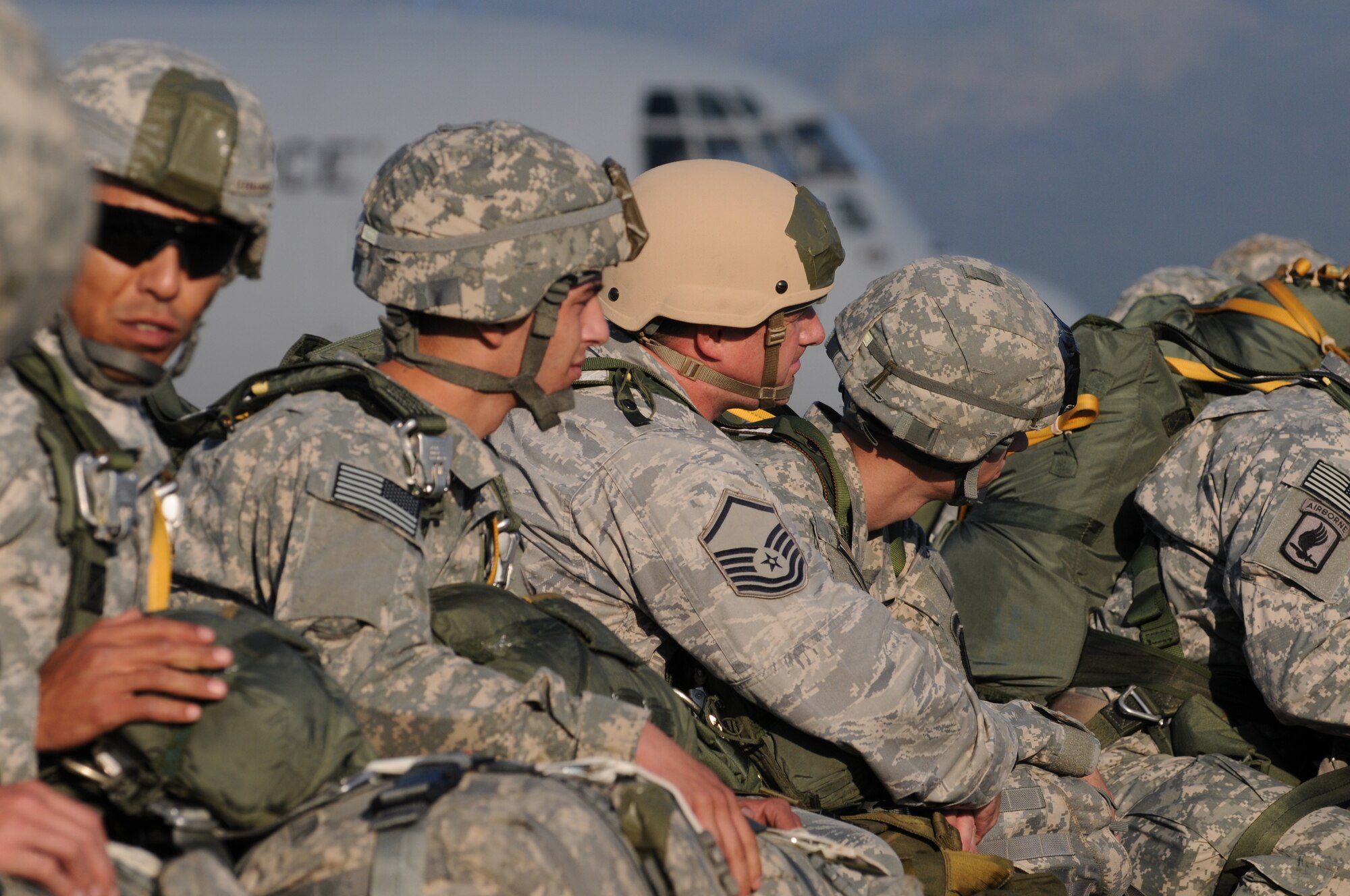 Master Sgt. Shawn Minyon (middle), 8th Air Support Operations Squadron superintendent, together with 173rd Airborne Brigade Combat Team Soldiers listen for jump instructions Oct. 5 at Aviano Air Base, Italy, before the team's first full-spectrum training operation in Europe. Minyon and other 8th ASOS members participated in the event. The 173rd ABCT, stationed at Vicenza, Italy, leads the efforts in the first brigade-sized operation in Europe since 2003 that includes more than 1,300 U.S. military an joint partner nation paratroopers. (U.S. Air Force photo/Staff Sgt. Nadine Barclay)