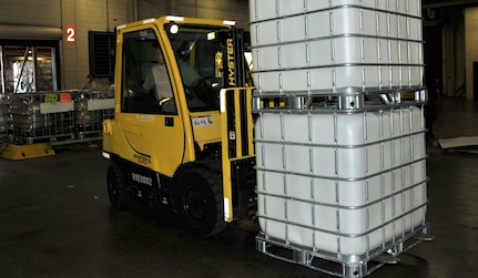 Staff Sgt. Michael Shaw backs up a forklift holding water purification systems Oct. 5, at Joint Base Charleston-Air Base. Humanitarian aid, including 20 reverse osmosis water purification systems and two anesthesia machines, will be sent to Colon, Honduras Oct. 25. These supplies will assist more than 20,000 Hondurans in need. Shaw is an air transportation journeyman from the 437th Aerial Port Squadron. (U.S. Air Force photo/2nd Lt. Leah Davis)