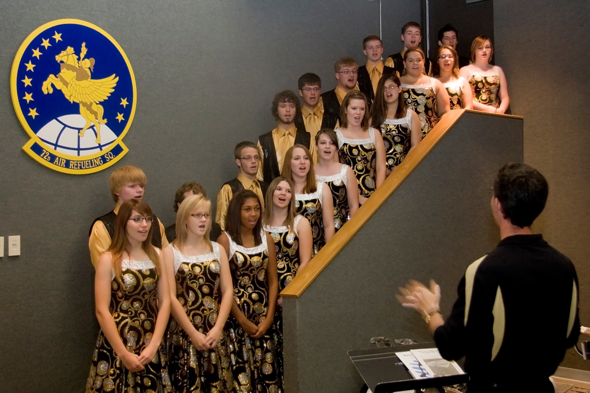 GRISSOM AIR RESERVE BASE, Ind. -- Peru High School's swing choir sings patriotic songs during a special base rededication ceremony held here Sept. 30. The base was originally named Bunker Hill Naval Air Station. It was renamed to Bunker Hill Air Force Base in 1947. In 1968, the base was once again renamed Grissom Air Force Base in honor of Lt. Col. Virgil I. "Gus" Grissom, the American astronaut who lost his life during a training mission aboard Apollo 1. In 1994, the base was realigned to be an Air Force Reserve Base and was named Grissom Air Reserve Base. (U.S. Air Force photo/Tech. Sgt. Mark R. W. Orders-Woempner) 
