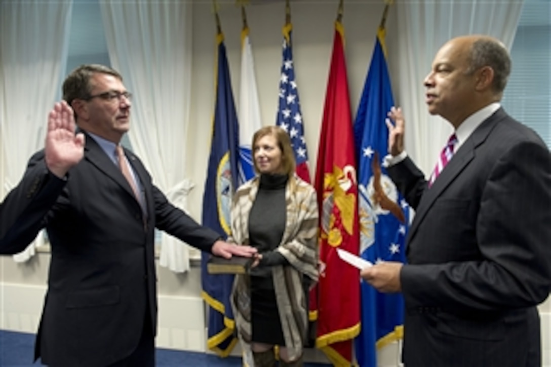 Ashton B. Carter (left) is administered the oath of office as the 31st Deputy Secretary of Defense by General Counsel of the Department of Defense Jeh C. Johnson, while Carter’s wife Stephanie holds the Bible, in a ceremony in the Pentagon in Arlington, Va., on Oct. 6, 2011.  Carter was formerly the Under Secretary of Defense for Acquisition, Technology & Logistics.   
