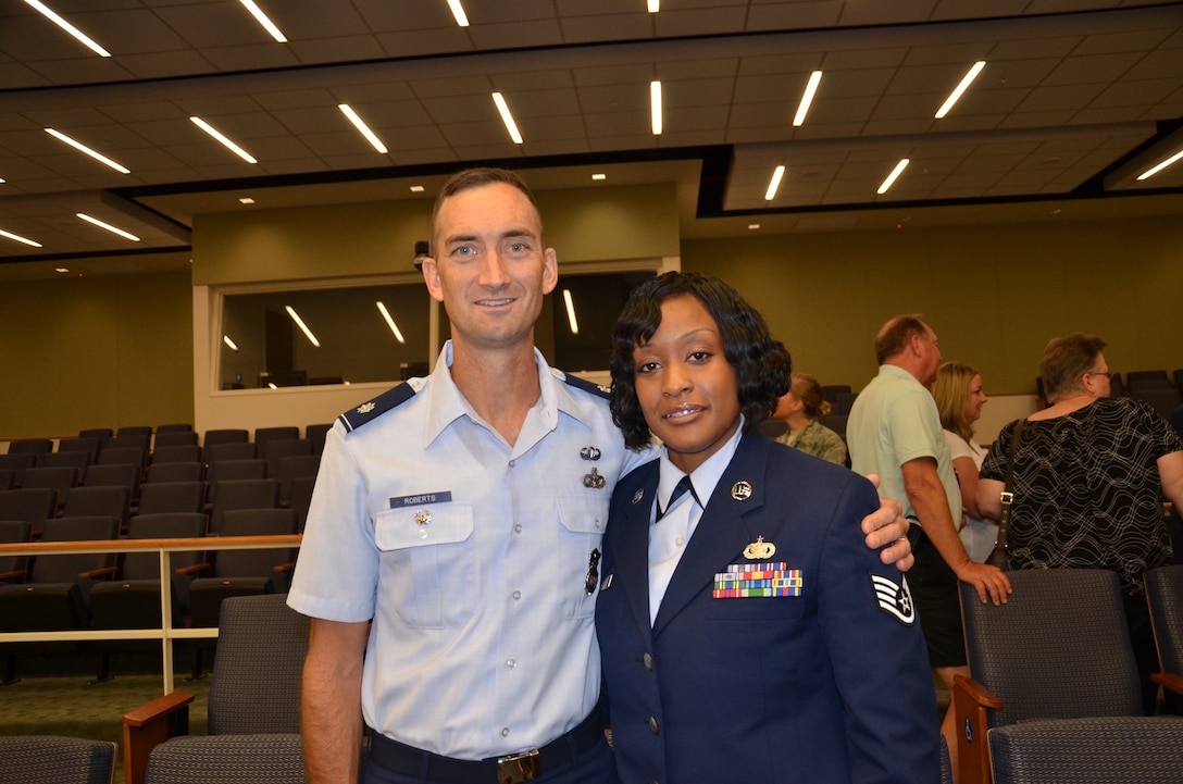 Air Force Staff Sgt. Deondra Parks with Lt. Col. Troy Roberts, her former commanding officer at the 72nd Security Forces Squadron who attended Parks' graduation from the Basic Medical Technician/Corpsman Program at the Medical Education & Training Campus (METC) in Fort Sam Houston, Texas.  Parks was enrolled in the program at 
Sheppard Air Force Base in 2010 but had to drop from training after she was shot. She returned to training in June 2011 at METC where the program is now being taught. (U.S. Navy photo by Lisa Braun/Released)
