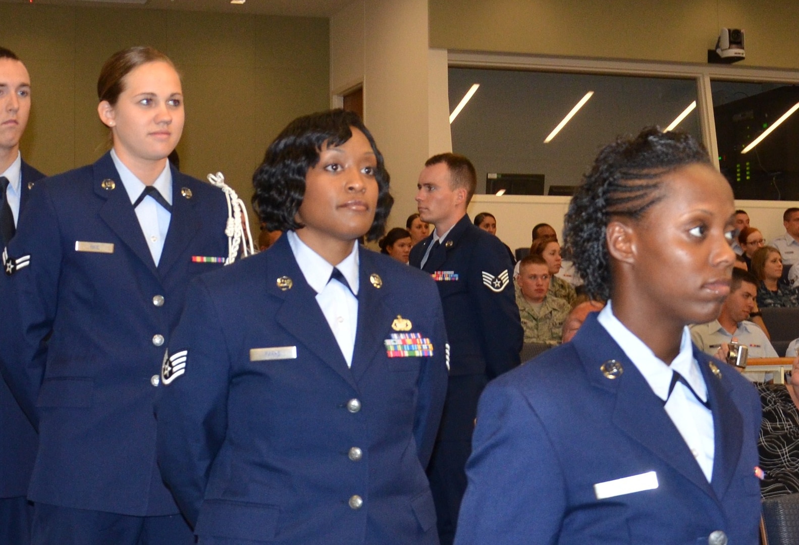 Air Force Staff Sgt. Deondra Parks (center) awaits her turn to receive her certificate of 
completion during the Basic Medical Technician/Corpsman Program graduation ceremony at the Medical Education & Training Campus (METC) in Fort Sam Houston, Texas. Parks was enrolled in the program at Sheppard Air Force Base in 2010 but had to drop from training after she was shot. She returned to training in June 2011 at METC where the program is now being taught. (U.S. Navy photo by Lisa Braun/Released)
