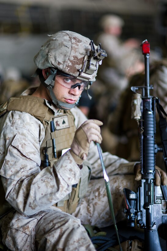 Rifleman Cpl. Scott Mackie waits to board a CH-53E Sea Stallion with Marine Medium Helicopter Squadron 268 (Reinforced) in the amphibious assault ship Makin Island's hangar here Oct. 6 before conducting a training raid. Mackie, 22, is from Huntington Beach, Calif., and serves with Company I, Battalion Landing Team 3/1. The battalion serves as the ground combat element for the 11th Marine Expeditionary Unit, which embarked USS Makin Island, USS New Orleans and USS Pearl Harbor in San Diego Sept. 28 and is participating in its final exercise before deploying in November.