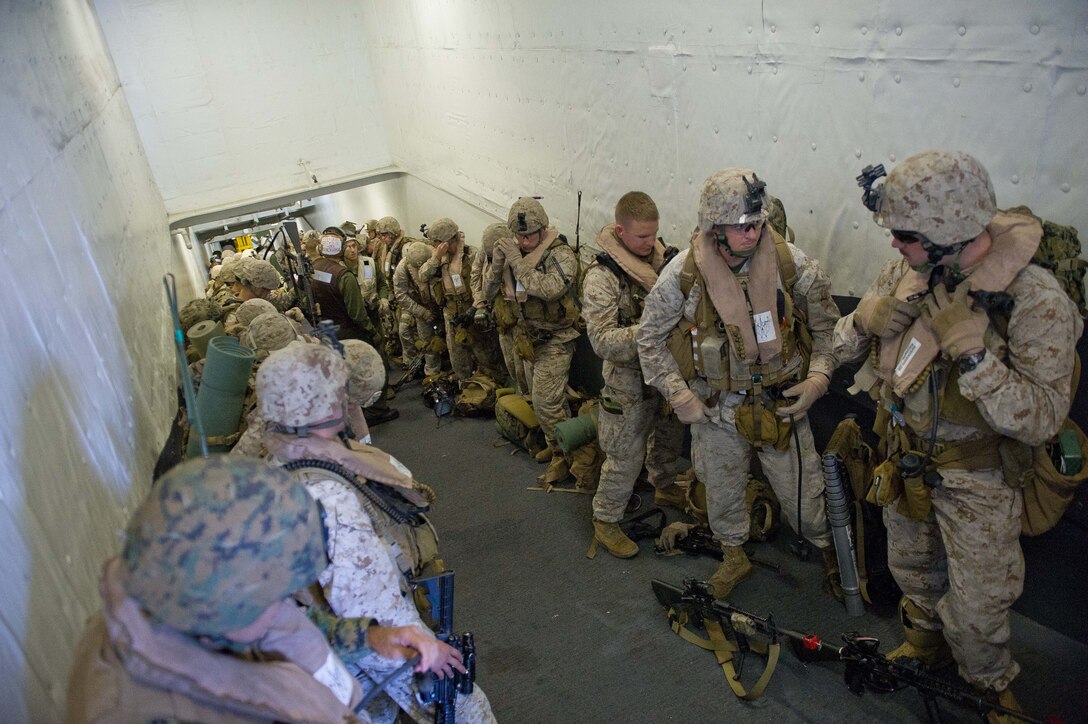Marines with Company I, Battalion Landing Team 3/1, wait to board a CH-53E Sea Stallion with Marine Medium Helicopter Squadron 268 (Reinforced) before conducting a training raid here Oct. 6. The battalion serves as the ground combat element for the 11th Marine Expeditionary Unit, which embarked USS Makin Island, USS New Orleans and USS Pearl Harbor in San Diego Sept. 28 and is participating in its final exercise before deploying in November.