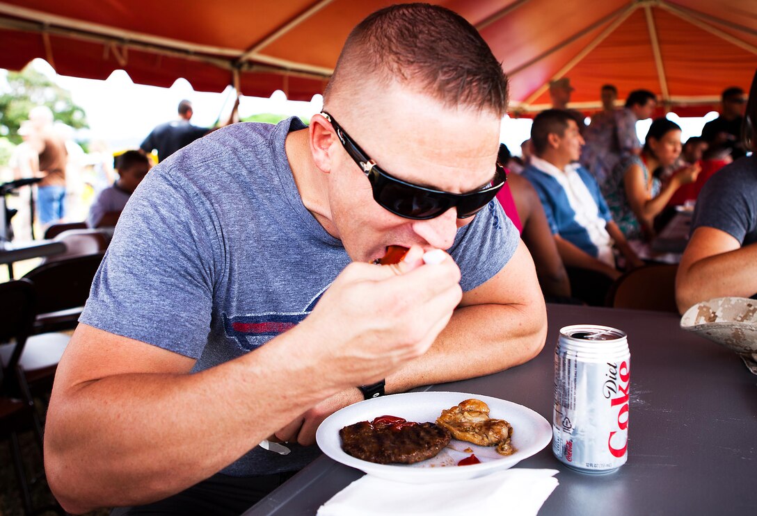Sgt. Ryan P. Hatch, a fiscal budget technician in the comptroller section, Headquarters and Service Battalion, U.S. Marine Corps Forces, Pacific, enjoys the barbecue at the Bordelon Bash held at Bordelon Field here Oct 7. The Bordelon Bash was a family fun day event hosted by the battalion.