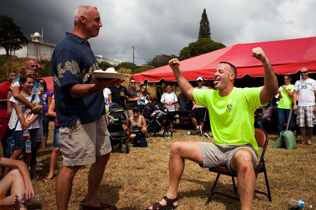 Col. Brent S. Willson, the commanding officer, Headquarters and Service Battalion, U.S. Marine Corps Forces, Pacific, prepares to put a pie in the face of Maj. Jan-Hendrick C. Zurlippe, officer-in-charge, comptroller section, HqSvcBn, at the Bordelon Bash at Bordelon Field here Oct 7. The Bordelon Bash was a family fun day event hosted by the battalion.